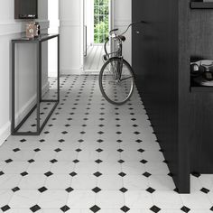 a black and white hallway with a bike parked in the door way next to it