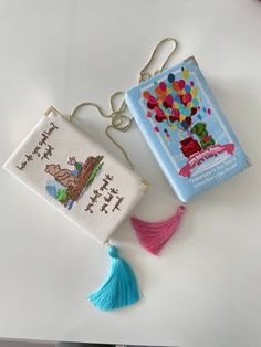 two cross - stitch bookmarks with tassels on them, one has a birthday card and the other has a balloon