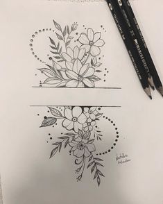 two pencils sitting next to each other on top of a piece of paper with flowers