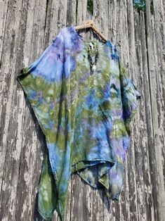 MONET Ice Dye Mini Kaftan, Beach Poncho or Tunic,  Regular or Plus Color Combo Name: ICE DYE MONET green-blue (looks like purple) Modeled in another color combo - a size Regular. I am 5'3", a size small. NECKLACE: See my Jewelry Section! This poncho/mini kaftan has a V-neckline and an armhole opening on the sides. The fabric is pre-shrunk super soft 100% woven rayon fabric. No need to iron it out of the dryer (I just dyed this beauty, and took it out of the dryer - it looks perfect!). Also, the wrinkles come out when hung for a while. 100% super-soft woven rayon Pre-Shrunk Machine wash and dry - the label calls for dry cleaning, but we have washed and dried it. Measurements:  REGULAR ONE SIZE;  Fits S-XL  41" wide -29½" between side stitching, 32" long PLUS ONE SIZE: 48" across, 37" across Multicolor Poncho For Beach Cover-up In Summer, One Size Blue Cover-up For Festival, Green Bohemian Poncho For Spring, Bohemian Green Poncho For Spring, Casual Multicolor Poncho For Vacation, One Size Bohemian Blue Cover-up, Bohemian Blue One-size Cover-up, Oversized Multicolor Poncho For The Beach, Oversized Multicolor Summer Poncho