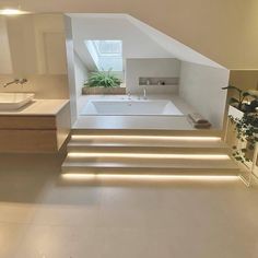 a bathroom with two sinks and a bathtub in the middle of an attic space