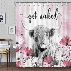 a shower curtain with an image of a cow and daisies on it, that says get naked