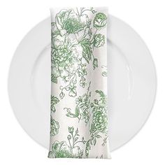 a white plate with a green floral napkin on it and a fork next to it