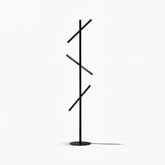 a black metal pole with three sticks sticking out of it's sides on a white background