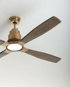 a ceiling fan with two wooden blades and a light on the bottom one is turned off