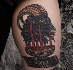 a tattoo on the leg of a person with an animal head and two red bars