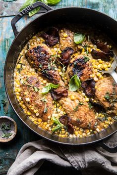 a skillet filled with chicken and corn