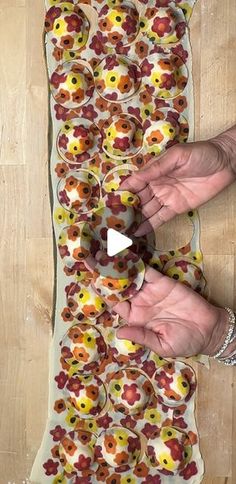 the person is making an art project out of doughnuts