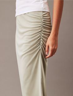 Cut in a flattering, fitted silhouette, this skirt is accentuated by soft ruching details at the waist. Designed in a midi length and styled with a medium rise waist. Made from smooth jersey fabric for a fluid touch.  Material: 100% Polyester. Chic Midi Bottoms With Gathered Waist, Spring Fitted Midi-length Draped Skirt, Casual Midi-length Bottoms With Gathered Waist, Spring Fitted Midi Draped Skirt, Casual Bottoms With Gathered Waist, Midi Length, Fitted Midi-length Draped Skirt For Spring, Fitted Midi-length Draped Skirt For Summer, Summer Fitted Midi Draped Skirt, Fitted Midi Draped Skirt For Summer