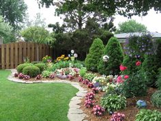 a garden with lots of flowers and trees