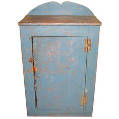 an old blue cabinet with rusted paint on the front and bottom, against a white background