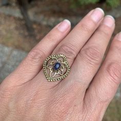 This ring makes a gorgeous statement. The polished black onyx stone is set in brass floral tribal design details. The back is open to allow direct contact with the stone. Ring is approx 7/8”length on face US size 7.75 Hypoallergenic Brass Bohemian Jewelry, Nickel-free Spiral Metal Jewelry, Spiritual Spiral Metal Jewelry, Spiral-shaped Pierced Metal Jewelry, Spiral Brass Wire Wrapped Jewelry, Spiral Wire Wrapped Brass Jewelry, Nickel-free Bronze Spiral Jewelry, Nickel-free Spiral Brass Jewelry, Black Onyx Stone