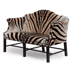 a zebra print chair sitting on top of a white floor