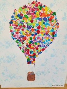 a child's drawing of a hot air balloon with lots of colored balloons floating in the sky