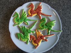 several decorated cookies on a white plate