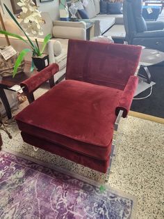 a red chair sitting on top of a purple rug