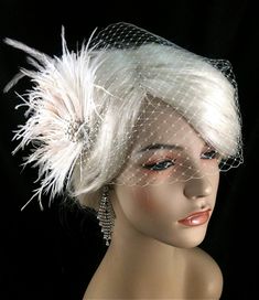 "Bridal Fascinator Feather Wedding Head Piece Feather Fascinator Bridal Hair Accessories Bridal Veil Set Gatsby Wedding Great Gatsby ~The Couture Bride~ https://www.etsy.com/shop/IceGreenEyes ~White ostrich feathers~ ~Ivory Ostrich Trim Feathers~ ~White Ostrich Trim Feathers~ ~Ivory/Champagne Peacock Flues~ ~2 Ivory/Champagne Peacock Feathers with large eyes~ ~Silver-tone Rhinestone and Pearl Brooch center piece~ ~Silver alligator clip~ ~Approximately 4\" x 5.5\"~ ~Works with an up-do or wear ha Wedding Hair Fascinator, Gold Wedding Gowns, Ivory Fascinator, Wedding Veil Vintage, Fascinator Wedding, Mini Hats, Vintage Headpiece, Bridal Fascinator, Fascinator Hairstyles