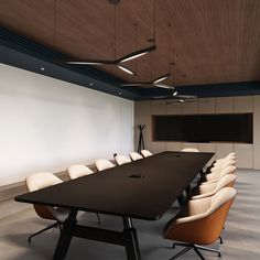 an empty conference table with chairs around it