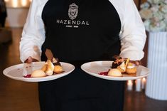 waiter with branded apron and dessert plates