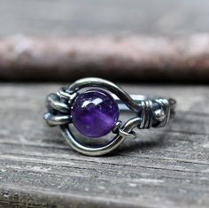 Amethyst sterling silver ringAn 8mm purple amethyst "floats" in a hand shaped sterling silver wire wrapped ring. ♥ The amethyst moves ♥ Handmade Amethyst Rings In Purple, Handmade Unique Open Ring Birthstone, Hand Wrapped Ring For Promise Ring, Hand Wrapped Ring For Promise, Sterling Silver Birthstone Rings For Healing, Adjustable Natural Stone Promise Ring, Handmade Open Crystal Ring For Healing, Amethyst Birthstone Crystal Ring, Handmade Adjustable Spiritual Birthstone Ring