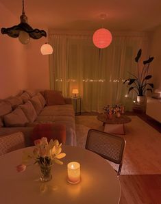 a living room filled with furniture and a lit candle on the table in front of it