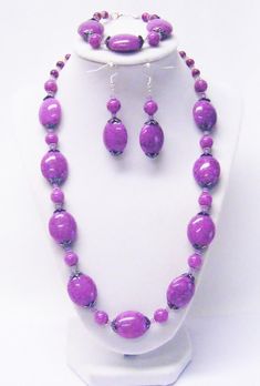 "Purple Splatter Chunky Oval Acrylic Bead Necklace/Bracelet/Earrings Set This necklace set is made with 20x24mm, beautiful, purple splatter oval acrylic beads, 10mm round purple splatter acrylic beads, 6mm round purple splatter glass beads, light purple glass E-beads, gum metal bead caps and silver plated spacer beads strung on flexible beading wire. It is 22\" in length, fastens with silver plated lobster clasp. It comes with bracelet and earrings that hang from silver plated fish hook ear wire Purple Jewelry With Large Round Beads, Adjustable Purple Jewelry With Large Beads, Purple Polished Beads Jewelry Gift, Purple Large Beads Jewelry Gift, Purple Large Beads Jewelry For Gift, Purple Jewelry With Polished Beads As Gift, Gift Purple Jewelry With Polished Beads, Gift Purple Large Beads Jewelry, Purple Polished Round Bead Jewelry