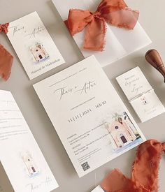 the wedding stationery is laid out on top of each other, including an orange ribbon