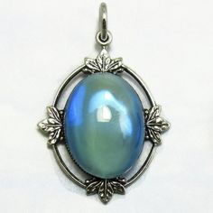 Vintage Glass Pendant Blue Opal Cabochon in Silver Art Deco Setting D-44 Vintage Oval Cabochon Moonstone Jewelry, Vintage Moonstone Jewelry Collectible, Vintage Blue Cabochon Jewelry, Blue Cabochon Moonstone Jewelry, Collectible Iridescent Cabochon Jewelry, Blue Vintage Cabochon Jewelry, Vintage Iridescent Gemstone Jewelry, Blue Antique Jewelry With Antique Finish, Vintage Opal Oval Cabochon Jewelry