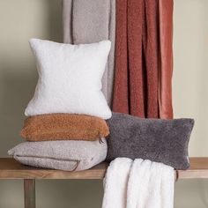 towels and pillows are sitting on a shelf