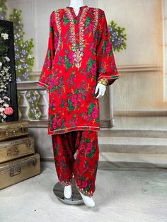 Embrace the vibrant cultural heritage of Sindh with this exquisite kurta salwar set. This kurta and salwar is adorned with intricate tilla embroidery, showcasing delicate gold threads that form traditional motifs. Complementing the tilla work are sparkling mirror embellishments, adding a touch of glamour and shimmer to the ensemble. The dress, crafted from soft, comfortable cotton fabric, provides a perfect balance of tradition and modern elegance. Ideal for festive occasions and cultural celebr Semi-stitched Traditional Wear With Printed Motifs For Eid, Traditional Red Palazzo Set With Dabka, Bollywood Style Dabka Salwar Kameez For Navratri, Traditional Jamawar Kurta With Printed Motifs, Traditional Jamawar Lawn Suit With Printed Motifs, Eid Unstitched Suit With Printed Motifs, Traditional Navratri Palazzo Set With Dabka Work, Festive Anarkali Lawn Suit In Mulmul, Navratri Palazzo Set With Dabka Work In Mulmul