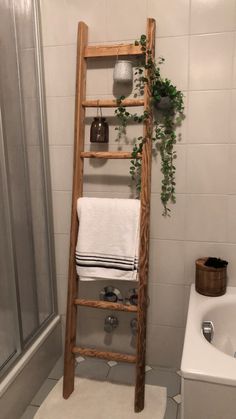 a wooden ladder in a bathroom next to a toilet