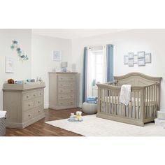 a baby's room with a dresser, crib and other furniture in it