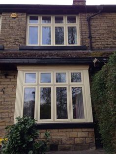 a brick house with white windows and black trim