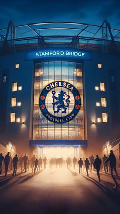 a stadium with people standing in front of it and the words chelsea on the side