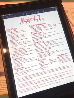 a tablet with a menu on it sitting in front of a table full of papers