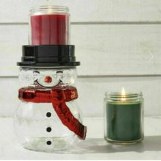 a snowman made out of a jar with a candle