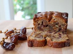 a loaf of fruit bread with raisins on a cutting board next to it