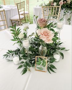 the centerpieces on this table are filled with flowers and greenery