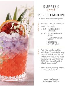 an orange and purple drink with ice on the rim, garnished with flowers