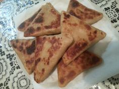 four pieces of flat bread sitting on top of a table