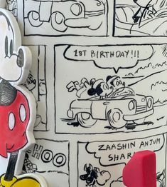 a mickey mouse birthday cake with comic strip background and cartoon character figurine next to it