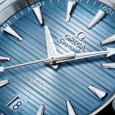 This 41 mm Aqua Terra, with a symmetrical case in polished and brushed stainless steel, has a blue rubber strap, which is integrated into the case and enhanced with a solid polished link in stainless steel. The teak pattern dial, in OMEGA’s own Summer Blue, is sun-brushed, PVD-treated, and varnished with a gradient finish to reflect the watch’s level of water resistance. It has rhodium-plated hands and indexes filled with a unique light blue Super-LumiNova and a matching blue date window indicat Modern Blue Automatic Watch Accessories, Modern Blue Watch With Polished Finish, Classic Blue Watches With Stainless Steel Clasp, Business Blue Watch Accessories With Polished Finish, Blue Polished Business Watches, Blue Polished Finish Business Watches, Blue Watch Accessories With Stainless Steel Clasp, Luxury Blue Watch With Polished Finish, Omega Co Axial