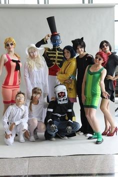 a group of people in costumes posing for a photo