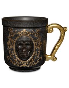 a black and gold coffee cup with a skull on it