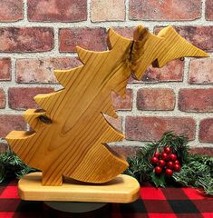 a wooden christmas tree sitting on top of a table