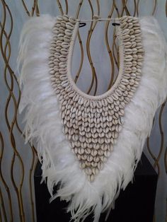 Papua Native Warrior necklace Full of natural creme shells and white feathers Stylish and elegant large necklaces with white natural shells Perfect for elegant parties and all kind of carnivals ! Size: 33 cm width x 45 cm high with stand : 48 cm high All our products are handmade, they can have slight imperfections, varied a little in size and colors. Gift wrapping and accompanying message possible. We also do wholesale to professionals. Perfect for elegant parties and all kind of Carnivals ! It White Bohemian Shell Necklace For Festival, Bohemian White Shell Necklace For Festival, Festival White Shell Necklace, White Shell Necklaces For Festivals, White Shell Necklaces For Festival, White Handmade Shell Necklace For Festivals, Handmade White Shell Necklace For Festivals, American Indian Decor, Native Warrior