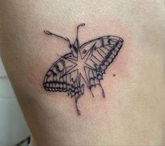 a butterfly tattoo on the back of a woman's stomach