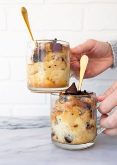 two people are holding spoons over some food in glass jars on a counter top