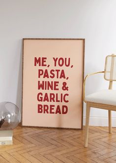 a framed poster with the words me, you, pasta, wine and garlic bread