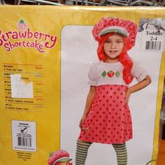 the doll is wearing a strawberry shortcake dress and matching hat with striped tights